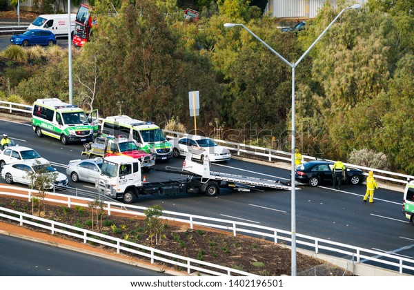 Tow truck\
collecting car after car accident on Graham Farmer Freeway in\
Perth, Western Australia. May 20,\
2019.
