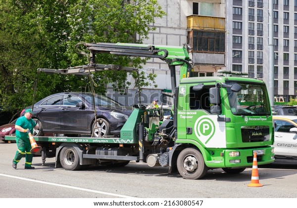 Tow truck is loading a car. Evacuation of\
parked cars that violate traffic rules. City traffic control\
service. Moscow, Russia -\
06.01.2022