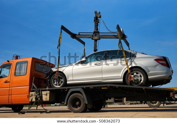 Tow truck loads smashed car after traffic\
accident\
                             \
