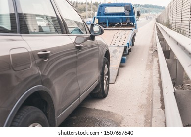  Tow Truck Towing A Broken Down Car On The Highway