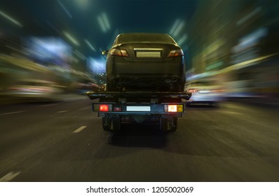 Tow Truck Transports The Car On The Night Street