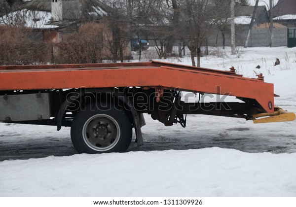 Tow truck in the winter\
on the road