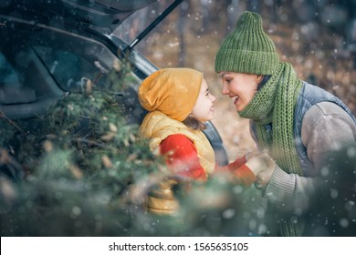 Toward Adventure! Happy Family Are Relaxing And Enjoying Road Trip. Mother, Child And Car On Snowy Winter Nature Background. Christmas Holidays Time.