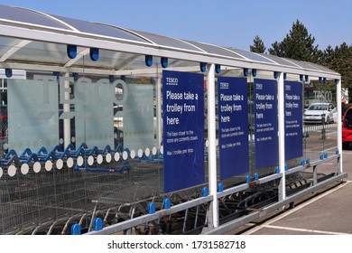 Towcester, Northamptonshire, England - May 7th 2020: Covered Supermarket Trolley Bays. Supermarket Trolley Collection And Return Point Located In Car Park During Covid-19 Pandemic.