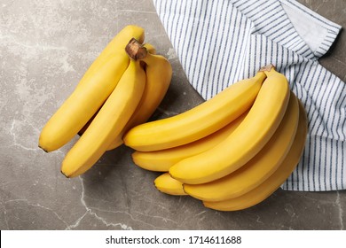 Towel and bananas on gray background. Fresh fruit