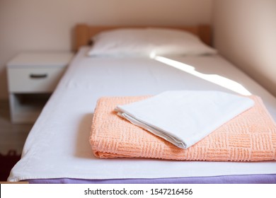 Towel And Bedding On A Single Bed In Hostel Or Guest House Room, No Reservations Guests Or Visitors, Empty No People Due To Outbreak Of Deadly Coronavirus (COVID-19) Global Pandemic Crisis, Cancelled 