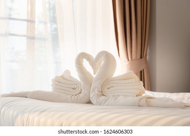 Towel Folded In Swan Shape On Bed Sheet In Bed Room