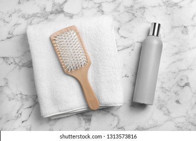 Towel, Hair Brush And Shampoo On Marble Background, Top View