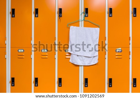 Towel hanging on locker in sport center.