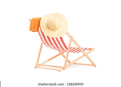 Towel and hat on a sun lounger with stripes, isolated on white background - Powered by Shutterstock