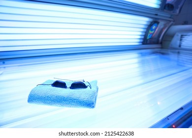 Towel and protective goggles on sunbed