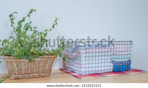 A towel in a\
wire basket. Image of\
laundry.