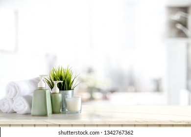 Towels And Ceramics Shampoo And Soap On Marble Counter In Bathroom Background.