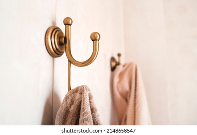 Towels hang on vintage stylish bathroom hooks in light shades. - Powered by Shutterstock