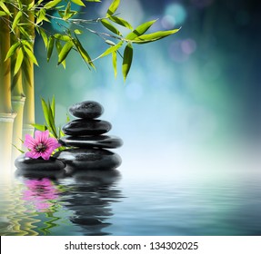tower black stone and hibiscus with bamboo on the water