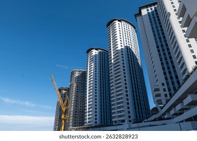 Tower blocks under construction on the beach, sunny with blue sky
