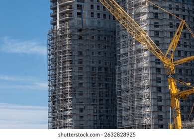 Tower blocks under construction on the beach, sunny with blue sky