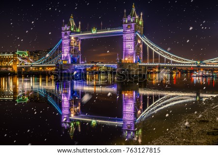Tower Bridge with Christmas lights and falling snow 