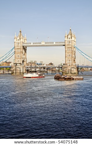 Tower Bridge, with ferry on the River Thames.