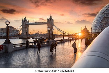 The Tower Bridge In London During Sunrise And People Rushing To Their Work