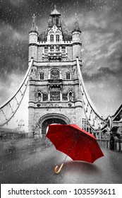Tower Bridge on River Thames with umbrella on a raining day. London, England. Black and white concept graphic with red element. 