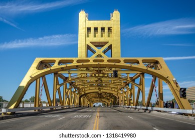 Tower Bridge Painted In Gold Color Taken From The Street And Showing Symetry Of The Structure In  Sacramento, California