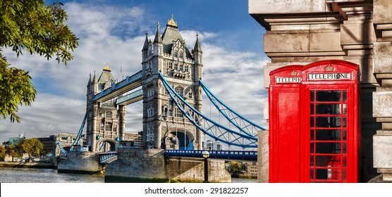 Tower Bridge with red phone booths in London, England, UK - Powered by Shutterstock