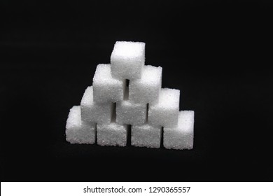 Tower Built Out Of Sugar White Cubes On An Isolated Black Background With Blank Space