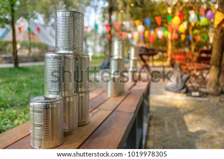 Tower of cans in front for throwing game at fun fair, Game shoot canned for outing party, Recreational pleasure