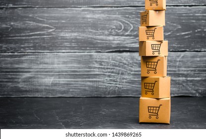 Tower Of Cardboard Boxes With Pattern Of Shopping Carts. Purchasing Power, Delivery Order. Sales Of Goods And Services. E-commerce, Logistics, Distribution. Commerce, Online Shopping. Copy Space