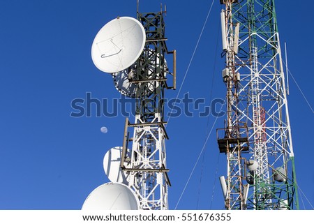 tower of communications with with a lot of different antennas under clear sky.
