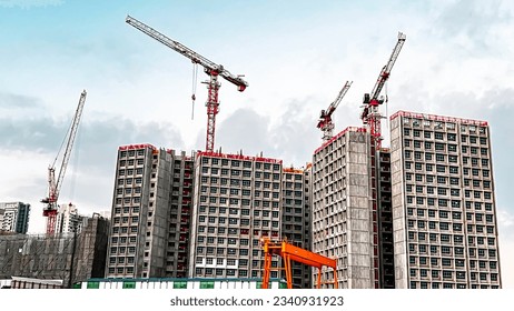 Tower crane in action to build multi-storey residential building.