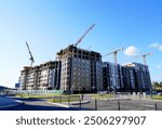 Tower Crane on building construction. Construction crane on Housing. Construction site, Multi Storey Residential Buildings construction. Formworks. Modern Townhome building. Modern House building.