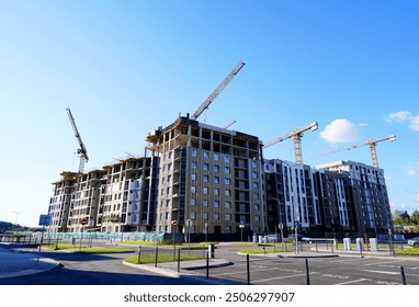 Tower Crane on building construction. Construction crane on Housing. Construction site, Multi Storey Residential Buildings construction. Formworks. Modern Townhome building. Modern House building.