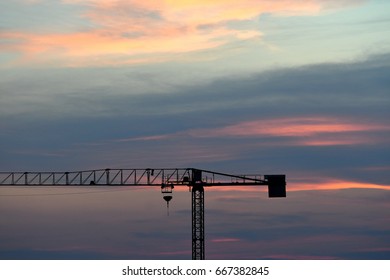 Tower crane on a construction site at sunset