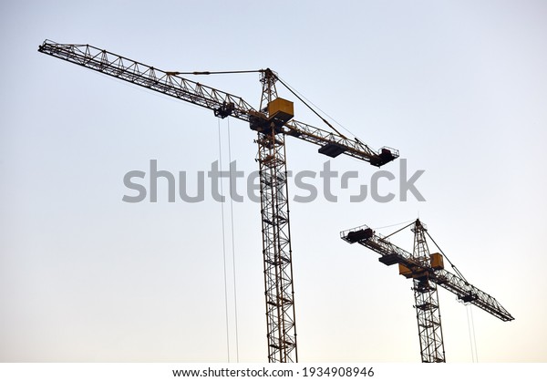 Tower cranes building a house. Concrete\
building under construction. Construction\
site