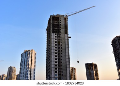 Tower cranes construct of new multi-storey buildings on construction site. Residential building is being constructed use of crane. Pouring of concrete in formwork. Renovation concept