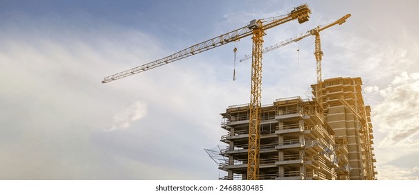 Tower cranes  at the construction site - Powered by Shutterstock