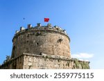 Hıdırlık Tower is a cylindrical tower built in the 2nd century on the city walls of Antalya. It was built on the seaside in Antalya Kaleiçi and the Turkish flag flies on its top.