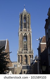 The tower of the Dom cathedral above a row of historical houses of Utrecht, Holland