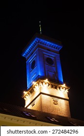 Tower floodlit at night from a dramatic wideangle perspective.