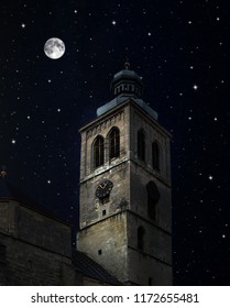 Tower Of The Gothic Church Against A Background Of Night Sky With Stars And Full Moon