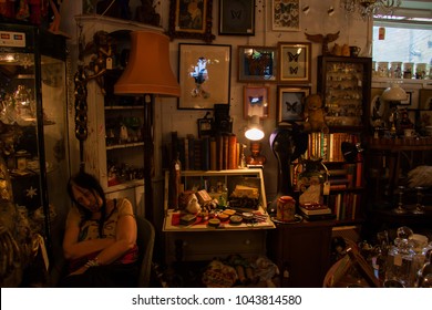 Tower Hamlets, London, UK - September 28 2014 : Old Female Shop Assistant Asleep On A Chair In An Antique And Collectables Shop In The Brick Lane Area Of London