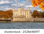 Tower of London along Thames river in autumn, UK