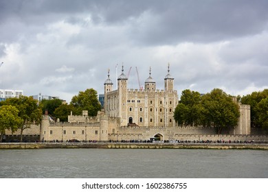 Tower Of London, A Castle And A Former Prison In London, England, Seen From The River Thames On A Cloudy Day. Museum Collections Include Famous British Crown Jewels