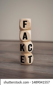 Tower made with cubes and dice with the words fake and fact - Shutterstock ID 1489041557