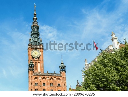 Tower of Main City Hall on Dluga street in the old city center of Gdansk, Poland. ClockTower built in 14th century. A walk through the city on a sunny summer day