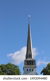 The tower of old white beautiful church in Arvika, Sweden