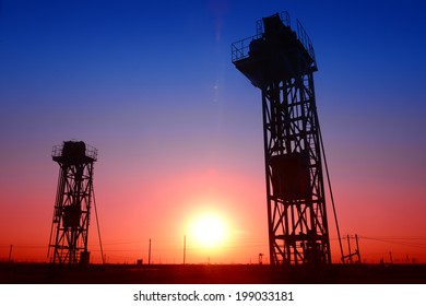 The tower of pumping unit operation in oil fields are being under the setting sun  - Shutterstock ID 199033181
