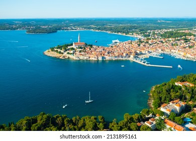 Tower of St. Euphemia church surrounded by traditional buildings of Rovinj. Bright red rooftops of houses in Croatian town in Adriatic sea. Aerial panorama